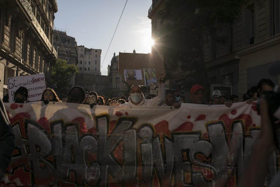 Protesters hold a banner that reads "Black Lives Matter" during a march against police brutality and racism in Marseille, France, Saturday, June 13, 2020, organized by supporters of Adama Traore, who died in police custody in 2016 in circumstances that remain unclear despite four years of back-and-forth autopsies. Several demonstrations went ahead Saturday inspired by the Black Lives Matter movement in the U.S. (AP Photo/Daniel Cole)