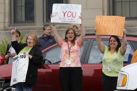 People cheer during a rally in support of law enforcement following the capture of David Sweat, in Malone, New York June 29, 2015. REUTERS/Chris Wattie