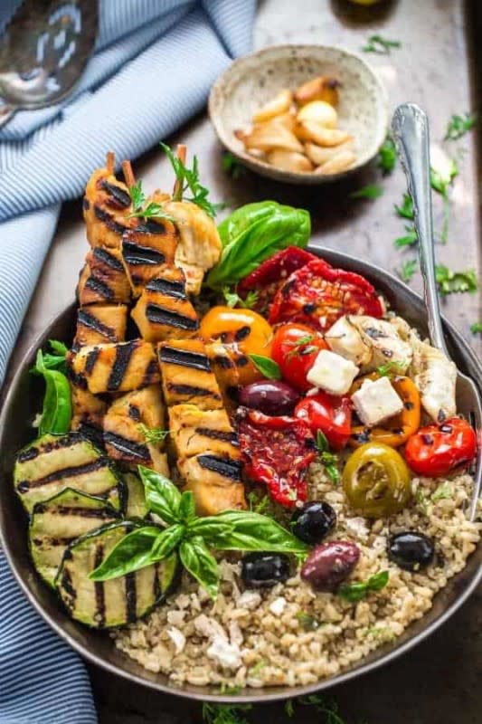 <p>Life Made Sweeter</p><p>Grilled Greek chicken souvlaki quinoa brown rice bowls—a Mediterranean-inspired weeknight chicken dish full of bright flavors served with grilled vegetables, olives and feta on a bed of quinoa and brown rice.</p><p><strong>Get the recipe: <a href="https://lifemadesweeter.com/grilled-chicken-souvlaki-quinoa-brown-rice-bowls/" rel="nofollow noopener" target="_blank" data-ylk="slk:Grilled Chicken Souvlaki Quinoa Brown Rice Bowls;elm:context_link;itc:0;sec:content-canvas" class="link rapid-noclick-resp">Grilled Chicken Souvlaki Quinoa Brown Rice Bowls</a></strong></p>