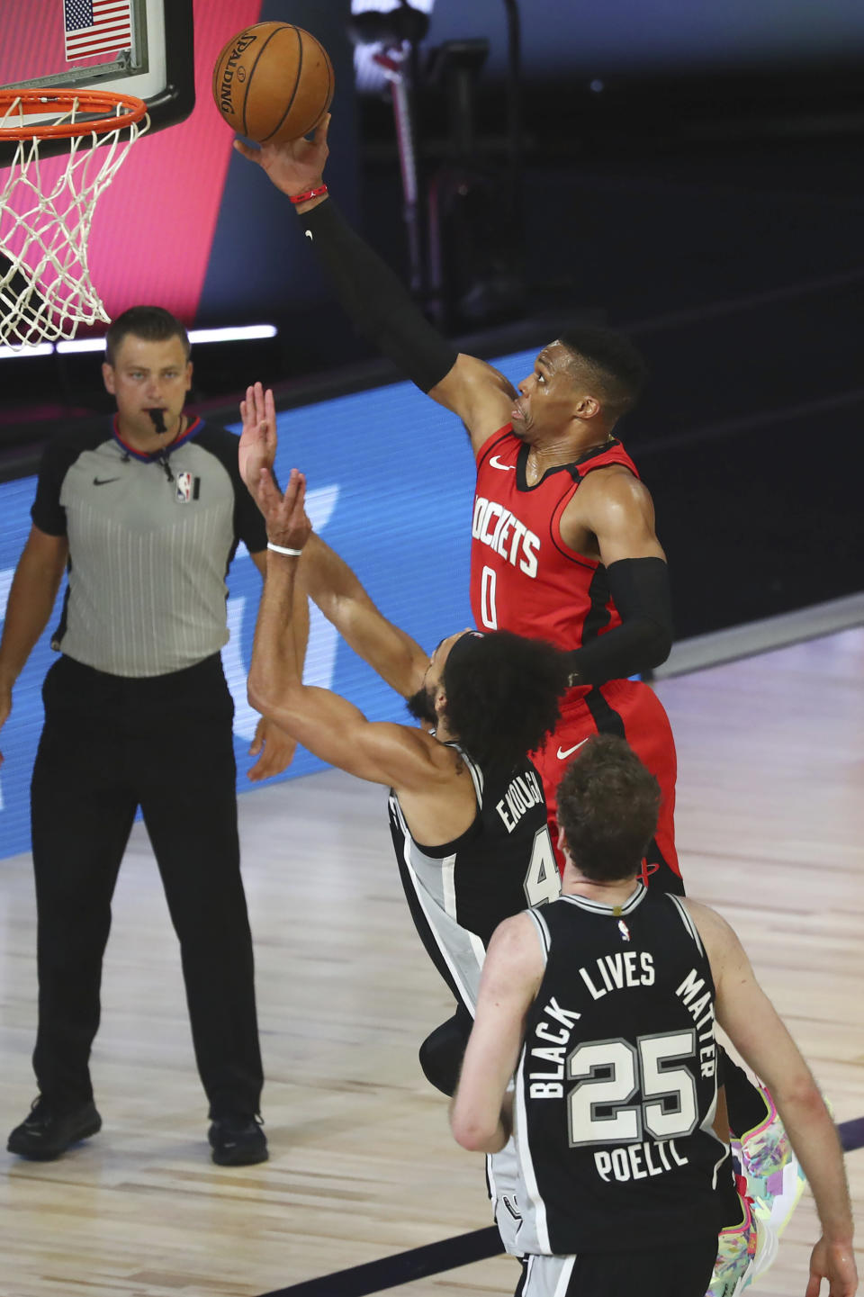 Houston Rockets guard Russell Westbrook (0) goes up for a shot past San Antonio Spurs guard Derrick White (4) during the second half of a NBA basketball game Tuesday, Aug. 11, 2020, in Lake Buena Vista, Fla. (Kim Klement/Pool Photo via AP)