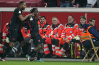 Leverkusen's Jeremie Frimpong, right, celebrates with team mate Leverkusen's Jonathan Tah after scoring his side's opening goal during the German soccer cup match between Bayer 04 Leverkusen and Fortuna Duesseldorf in Leverkusen, Germany, April 3, 2024. (AP Photo/Martin Meissner)