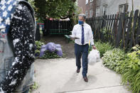 Philadelphia District Attorney candidate Carlos Vega brings food to his meet and greet event at Read Ready Daycare and Early Learning Academy in Philadelphia, on Sunday, May 16, 2021. Vega is challenging incumbent District Attorney Larry Krasner and both candidates are making a final push for votes before the election on May 18. (Elizabeth Robertson/The Philadelphia Inquirer via AP)