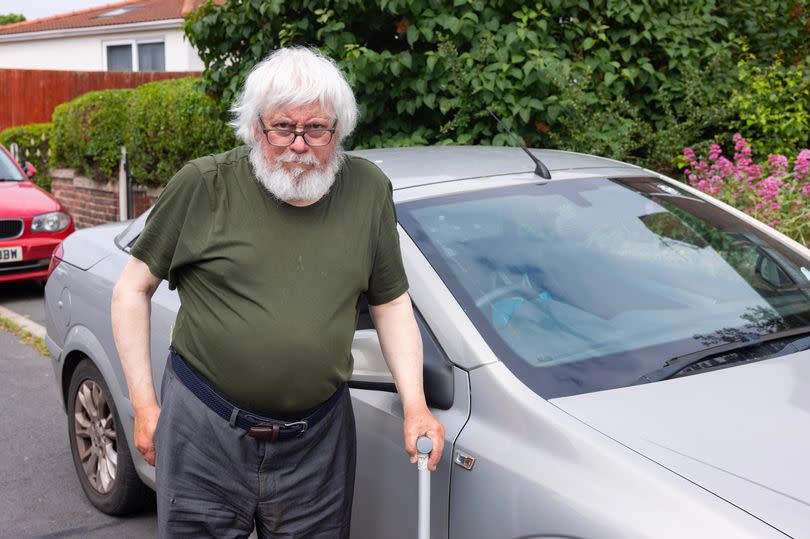 Ralph James with his blue badge in Bootle