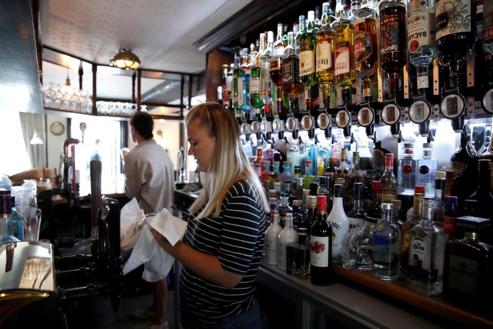 Staff from The Millstream Pub clean ahead of pubs reopening following the coronavirus disease (REUTERS)