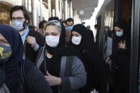 FILE - In this Oct. 11, 2020, file photo, people wear protective face masks to help prevent the spread of the coronavirus in downtown Tehran, Iran. As coronavirus infections reached new heights in Iran, overwhelming its hospitals and driving up its death toll, the country’s health minister gave a rare speech criticizing his own government’s refusal to enforce basic health measures. (AP Photo/Ebrahim Noroozi, File)