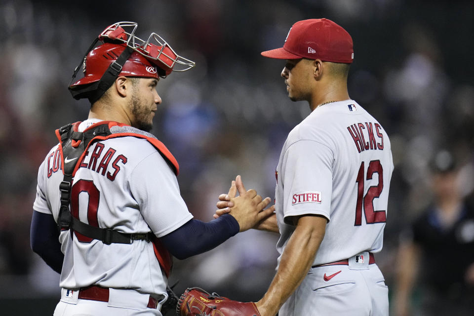 St. Louis Cardinals relief pitcher Jordan Hicks (12) celebrates with Cardinals catcher Willson Contreras after the final out against the Arizona Diamondbacks during the ninth inning of a baseball game Monday, July 24, 2023, in Phoenix. The Cardinals won 10-6. (AP Photo/Ross D. Franklin)