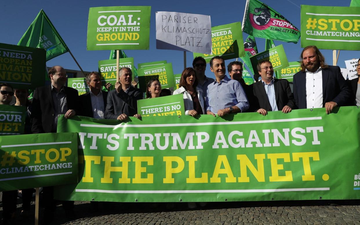 Members of the German Greens Party (Buendnis 90/Die Gruenen), including party co-heads Katrin Goering-Eckardt and Cem Oezdemir (C), protest outside the U.S. Embassy against the announcement by U.S. President Donald Trump the day before that he will pull the USA out of the Paris Agreement on June 2, 2017 - Getty Images Europe