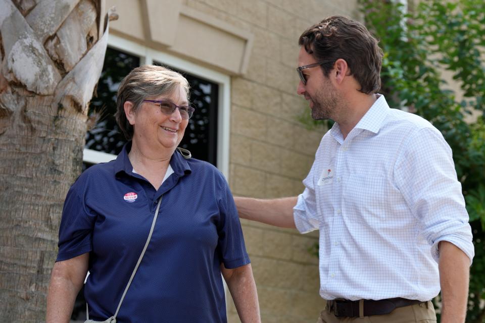 Former U.S. Rep. Joe Cunningham, right, speaks with voter Tamara Kirshtin, left, after Kirshtin voted for Cunningham in South Carolina's Democratic gubernatorial primary election on Tuesday, June 14, 2022, in North Charleston, S.C. (AP Photo/Meg Kinnard)