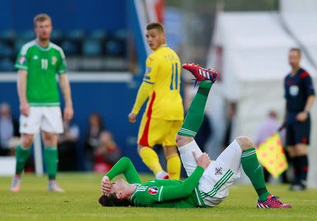 Football - Northern Ireland v Romania - UEFA Euro 2016 Qualifying Group F - Windsor Park, Belfast, Northern Ireland - 13/6/15 Northern Ireland's Kyle Lafferty lies on the pitch after appearing to sustain an injury Action Images via Reuters / Jason Cairnduff Livepic