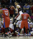 Stanford forward Dwight Powell (33) works on a save as Dayton forward/center Jalen Robinson (12) and Dayton guard Scoochie Smith (11) look on during the first half in a regional semifinal game at the NCAA college basketball tournament, Thursday, March 27, 2014, in Memphis, Tenn. (AP Photo/Mark Humphrey)