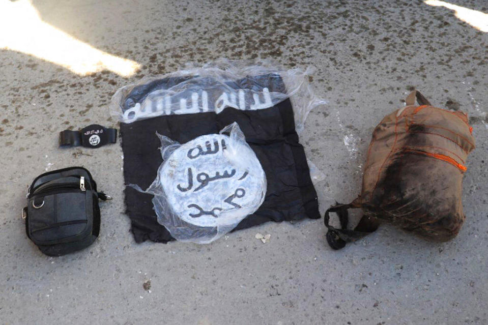 This photo provided by the Kurdish-led Syrian Democratic Forces shows the flag and bags of Islamic State group fighters who were arrested by the Syrian Democratic Forces after they attacked Gweiran prison, on January 21, 2022.  / Credit: Kurdish-led Syrian Democratic Forces, via AP