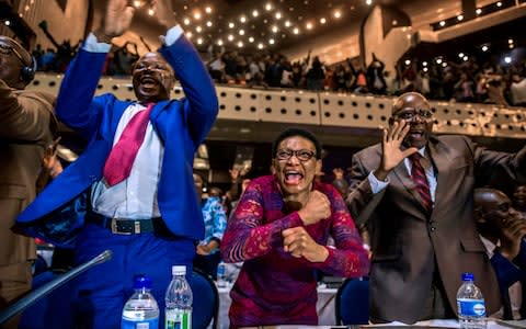 MP's jumped up and cried out in jubilation  - Credit:  JEKESAI NJIKIZANA/ AFP