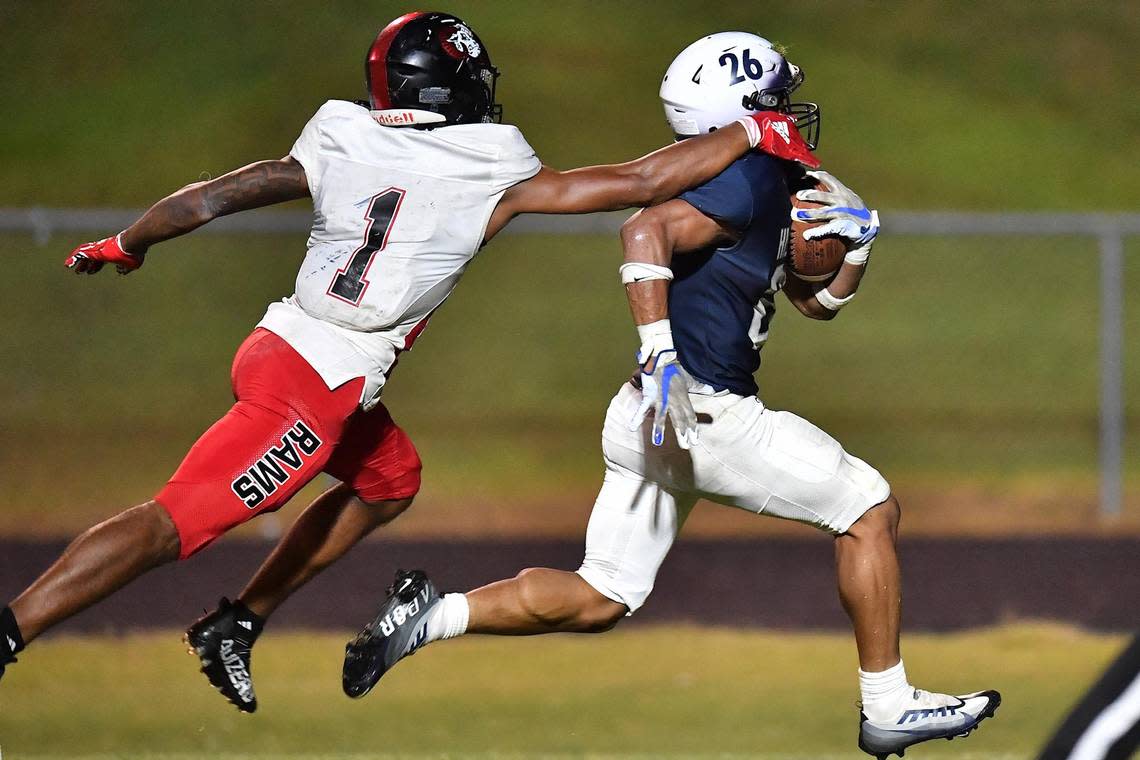 Hillside’s Jimmyll Williams (26) sprints for the touchdown against Rolesville’s Tamarcus Cooley (1) during the second half. The Durham Hillside Hornets and the Rolesville Rams met in a football game in Durham, N.C. on September 9, 2022.