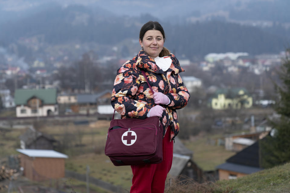 Dr. Viktoria Mahnych, poses for a photo prior to her interview with the Associated Press in Verhovyna village, Ivano-Frankivsk region of Western Ukraine, Wednesday, Jan. 6, 2021. Mahnych fears that a lockdown in Ukraine came too late and the long holidays, during which Ukrainians frequented entertainment venues, attended festive parties and crowded church services, will trigger a surge in new coronavirus infections. (AP Photo/Evgeniy Maloletka)