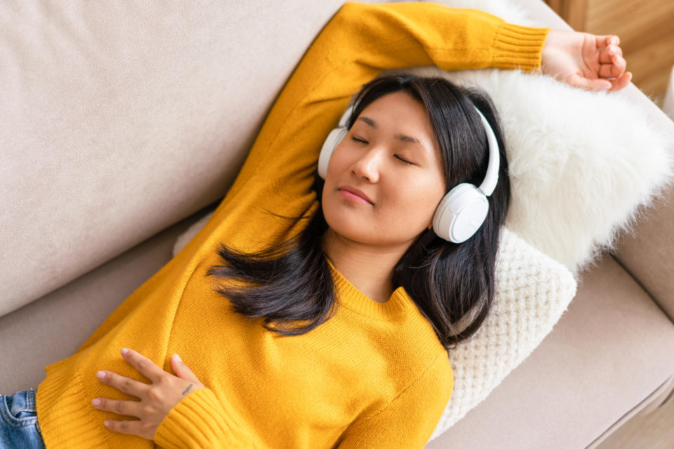 someone wearing headphones on the couch