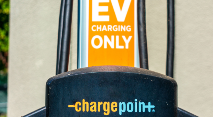 Selective focus. Detail of ChargePoint commercial EV electric vehicle charging station on uncovered parking lot. CHPT stock