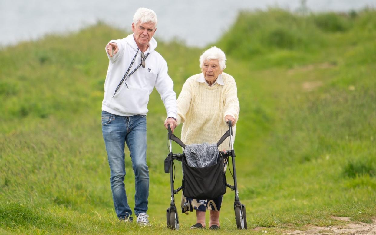 Phillip Schofield walking with his mother Pat. The presenter is said to be upset at his demise from the popular ITV daytime show - Spartacus/Splash News