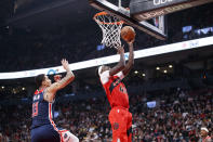 Toronto Raptors forward Pascal Siakam (43) drives to the net with Washington Wizards forward Kyle Kuzma (33) defending during first-half NBA basketball game action in Toronto, Sunday, Dec. 5, 2021. (Cole Burston/The Canadian Press via AP)