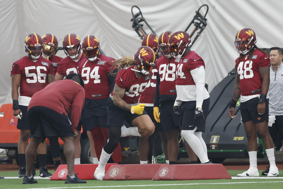 Washington Commanders defensive end Chase Young (99) participates in a drill on day three of minicamp at OrthoVirginia Training Center at Commanders Park. Mandatory Credit: Geoff Burke-USA TODAY Sports