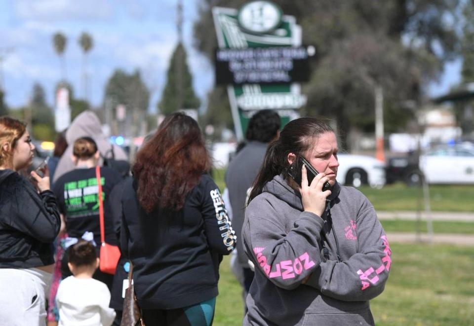 Conceerned parents gather outside Herbert Hoover High School after a hoax call from outside the area forced a lockdown Friday around noon, March 24, 2023 in Fresno.