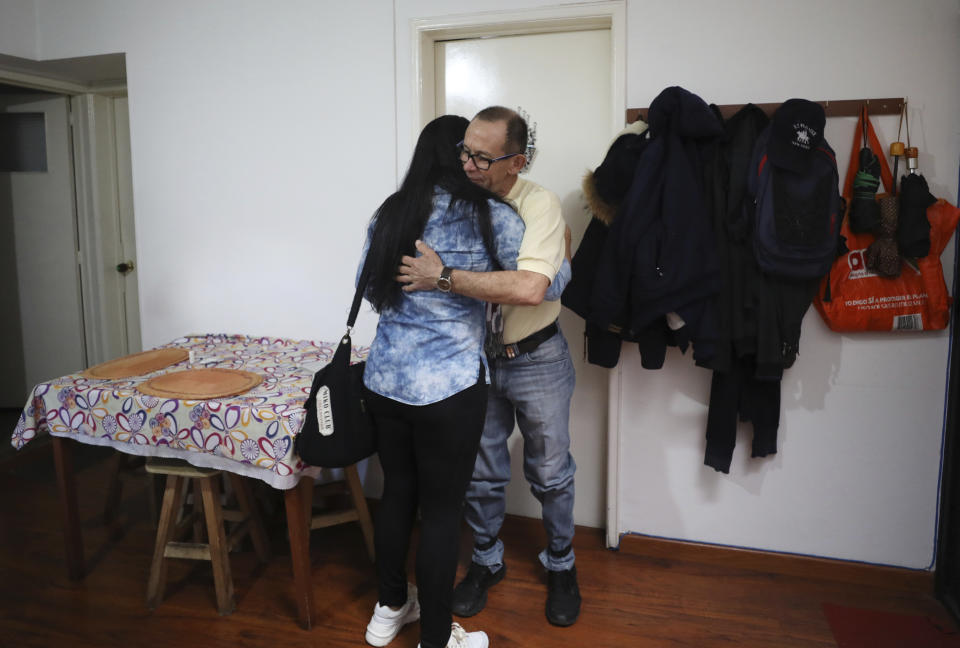 Venezuelan Rappi bicycle courier Luis Tarre, 60, embraces his wife Dingle Gonzalez before they start their workdays in Bogota, Colombia, Wednesday, July 17, 2019. Dingle found a job at a restaurant but occasionally works as a Rappi courier on her extra time to bring home some additional income. (AP Photo/Fernando Vergara)