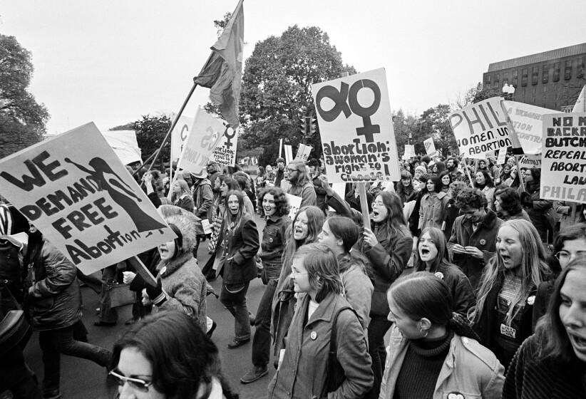 Demonstrators demanding a woman's right to choose march to the U.S. Capitol for a rally seeking repeal of all anti-abortion laws in Washington, D.C., Nov. 20, 1971. On the other side of the Capitol was a demonstration held by those who are against abortion. (AP Photo)
