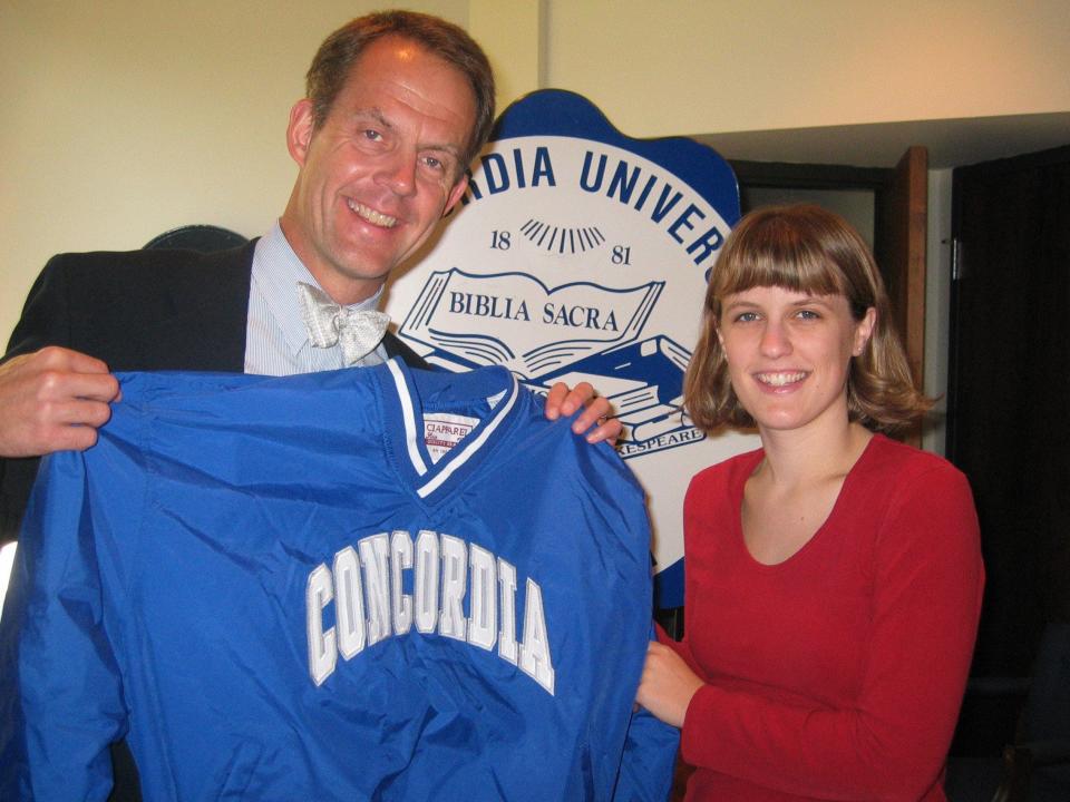 Concordia University Wisconsin President President Patrick Ferry presents Heather Groggel with a Concordia sweatshirt to wear during her stint in the College Championship tournament on "Jeopardy!" in 2003.