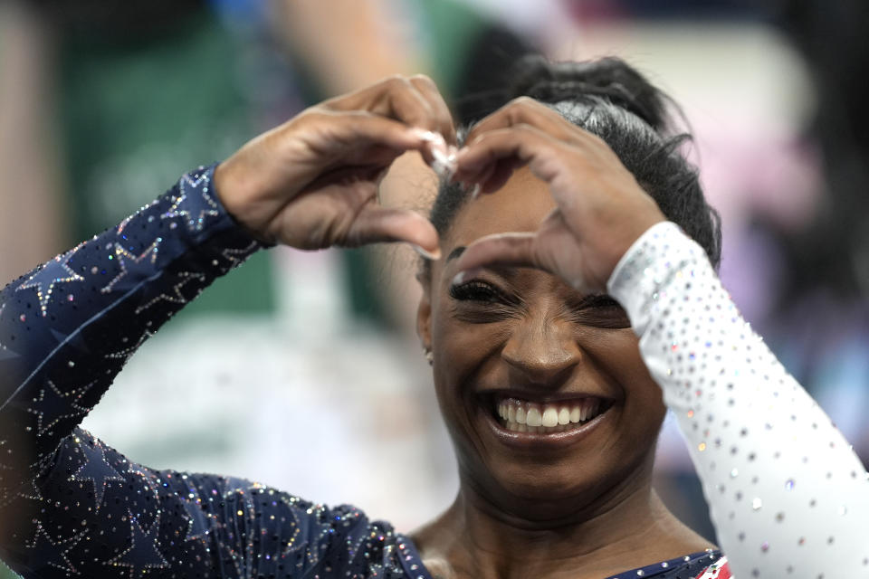 Simone Biles makes a heartfelt gesture to the crowd at the Bercy Arena in Paris.