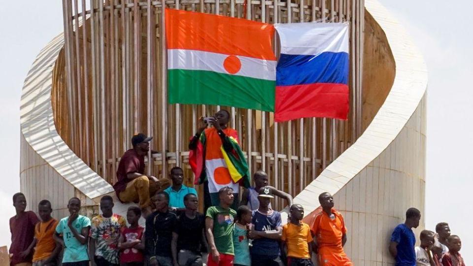 Demonstrators display the flags of Niger and Russia during a protest in Niamey, Niger, 30 July 2023.