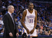 Oklahoma City Thunder forward Kevin Durant (35) laughs as he talks with Sacramento Kings head coach Michael Malone in the fourth quarter of an NBA basketball game against the Kings in Oklahoma City, Sunday, Jan. 19, 2014. Oklahoma City won 108-93. (AP Photo/Sue Ogrocki)