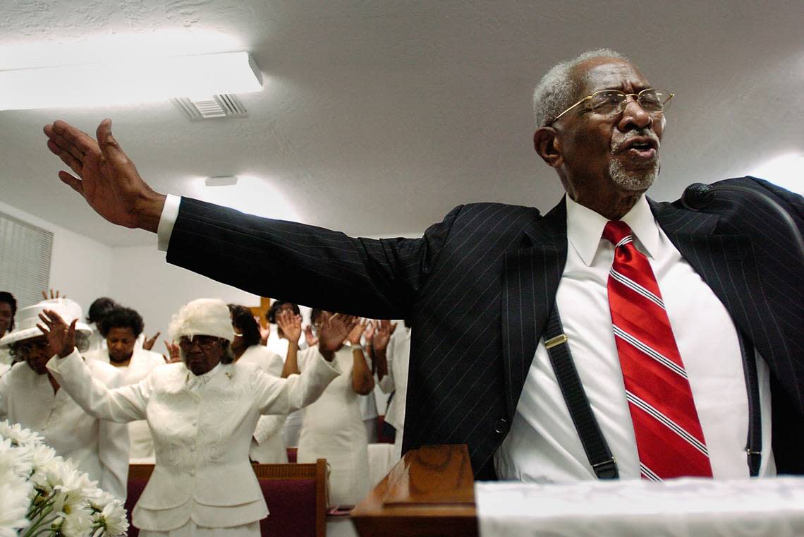 Bishop Walter H. Richardson, right, leads his congregation in a Benediction during a Sunday morning service at The Church of God Tabernacle in Liberty City, Florida, Sunday, May 20, 2007.