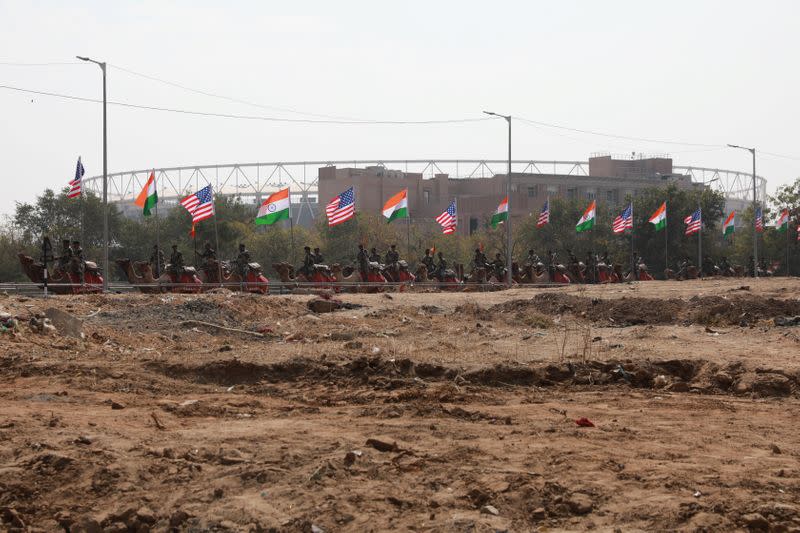 Border Security Force (BSF) soldiers ride their camels as they take part in a rehearsal for a road show ahead of the visit of U.S. President Donald Trump, in Ahmedabad