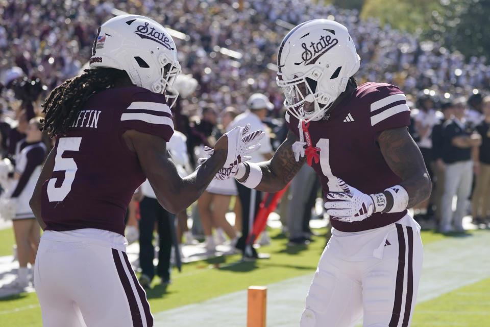 Mississippi State wide receiver Lideatrick Griffin (5) celebrates his 8-yard touchdown reception with wide receiver Zavion Thomas (1) during the first half of an NCAA college football game against Southern Miss in Starkville, Miss., Saturday, Nov. 18, 2023. (AP Photo/Rogelio V. Solis)