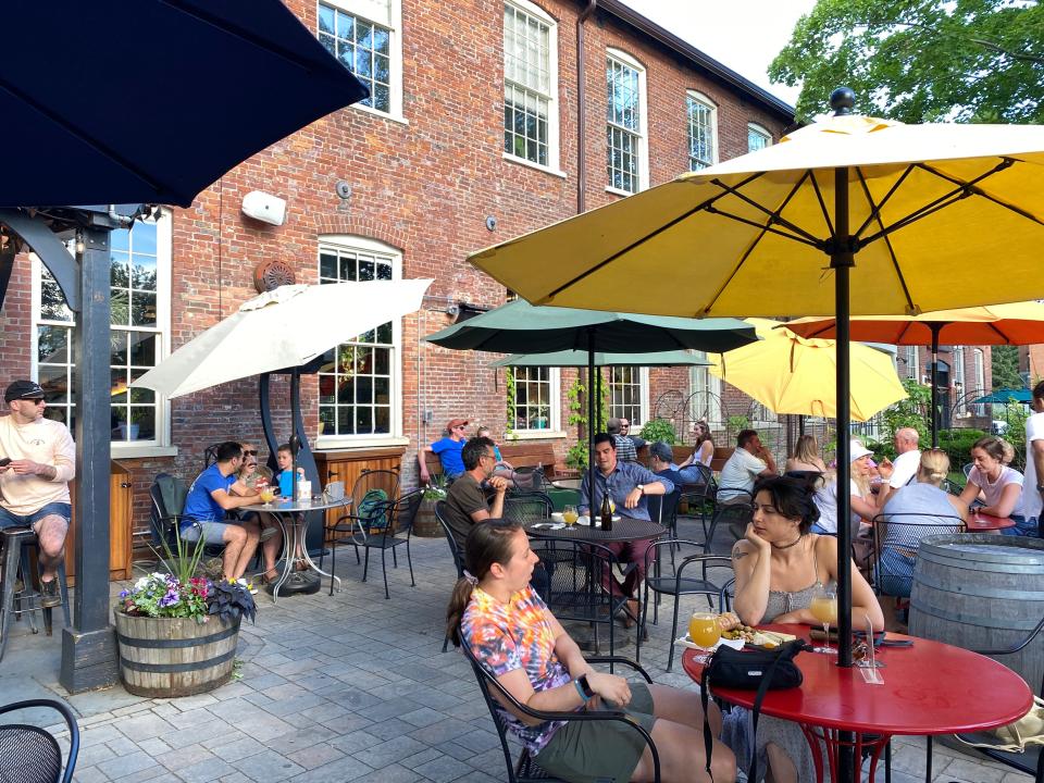 Cooled by breezes from Lake Champlain, people relax at Foam Brewers in Burlington, Vt. The waterfront entertainment district and the Church Street Marketplace enliven Vermont’s largest city.