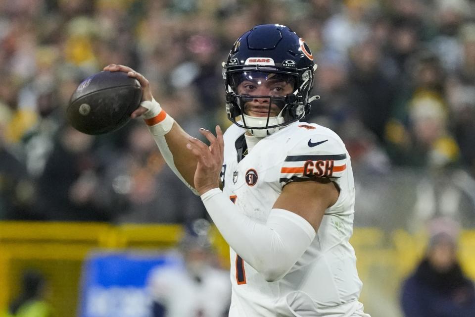 FILE - Chicago Bears' Justin Fields throws during the first half of an NFL football game against the Green Bay Packers Sunday, Jan. 7, 2024, in Green Bay, Wis. Bears quarterback Justin Fields says he wants to remain in Chicago and is tired of the trade talk surrounding him. Fields made his feelings clear during an episode of the “St. Brown Brothers” podcast that was released on Wednesday, Feb. 21, 2024.(AP Photo/Morry Gash, File)