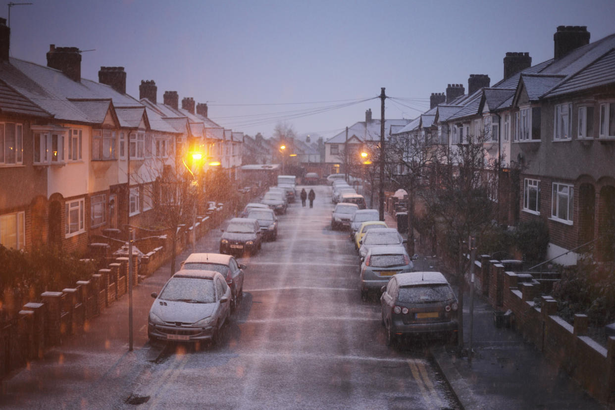 The view from a first floor window, down a suburban street on a cold, snowy morning.