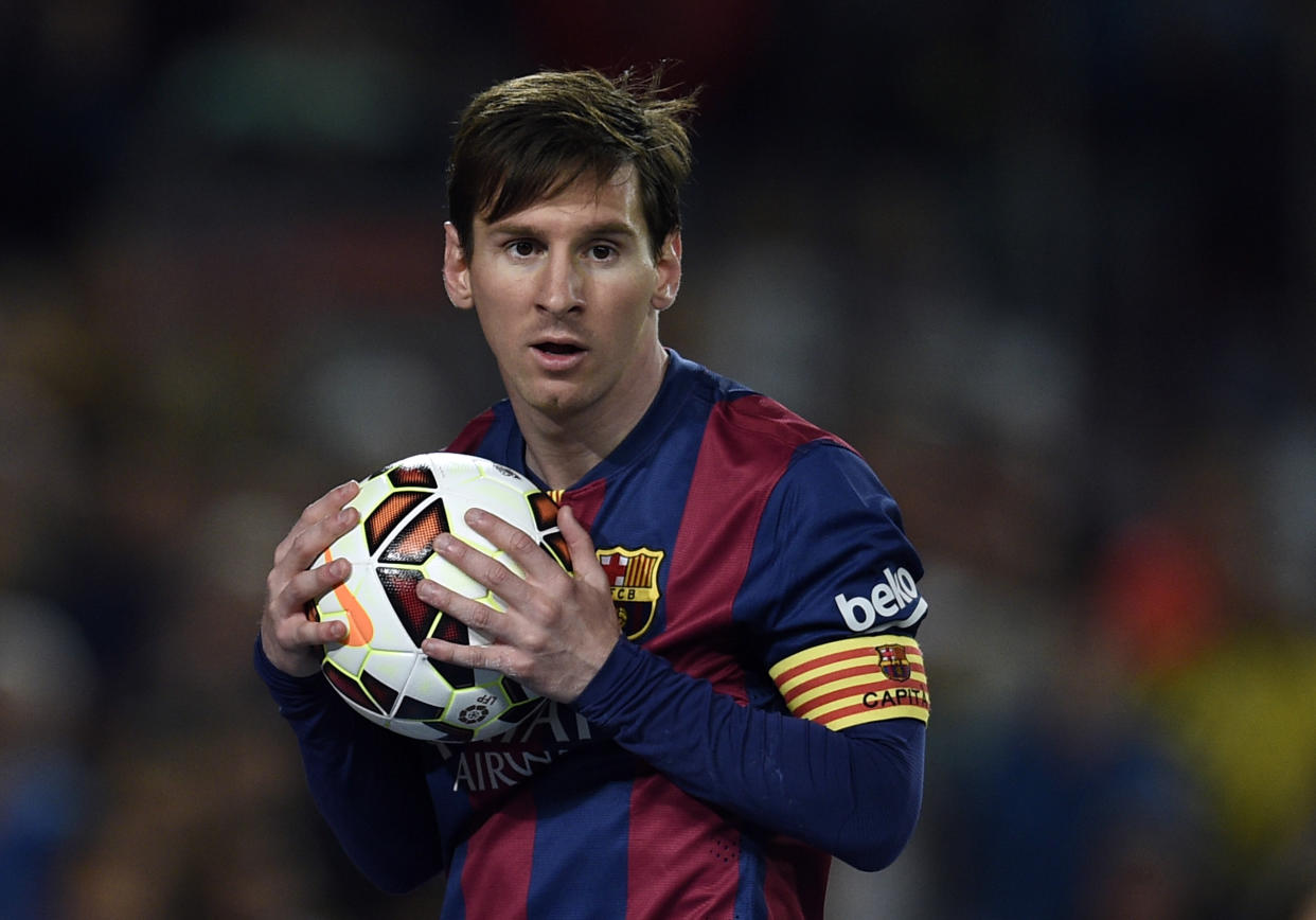 El argentino Lionel Messi, del Barcelona, sostiene la pelota con sus manos en el partido contra el Getafe por la Liga española el 28 de abril de 2015, jugado en el estadio Camp Nou, en Barcelona (AFP | LLUIS GENE)