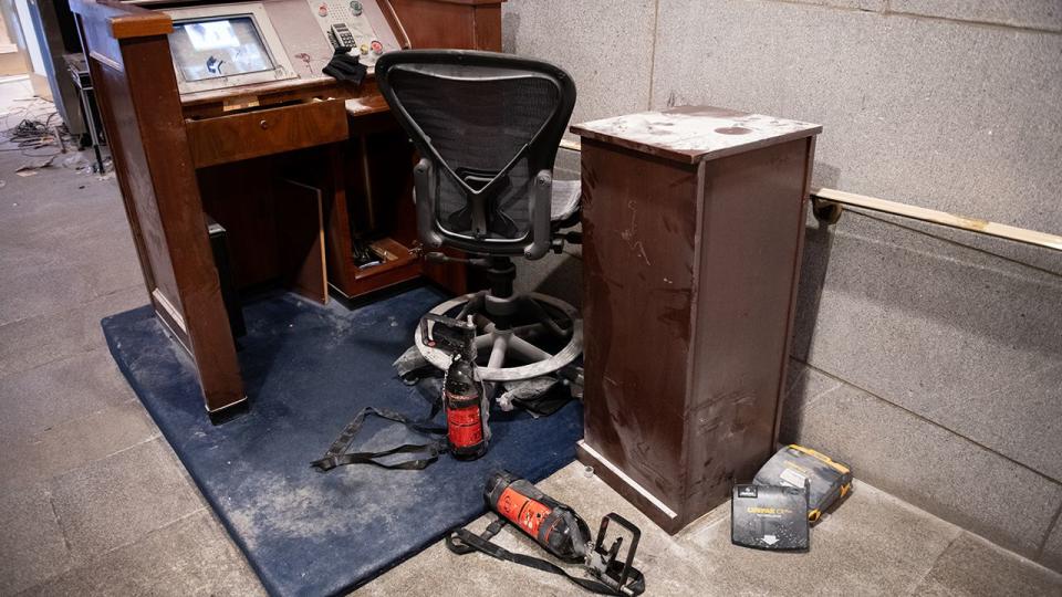 Chemical irritant canisters at a security checkpoint desk covered in dust at the U.S. Capitol building in Washington, D.C., U.S., on Thursday, Jan. 7, 2021. Joe Biden was formally recognized by Congress as the next U.S. president early Thursday, ending two months of failed challenges by his predecessor, Donald Trump, that exploded into violence at the U.S. Capitol as lawmakers met to ratify the election result.