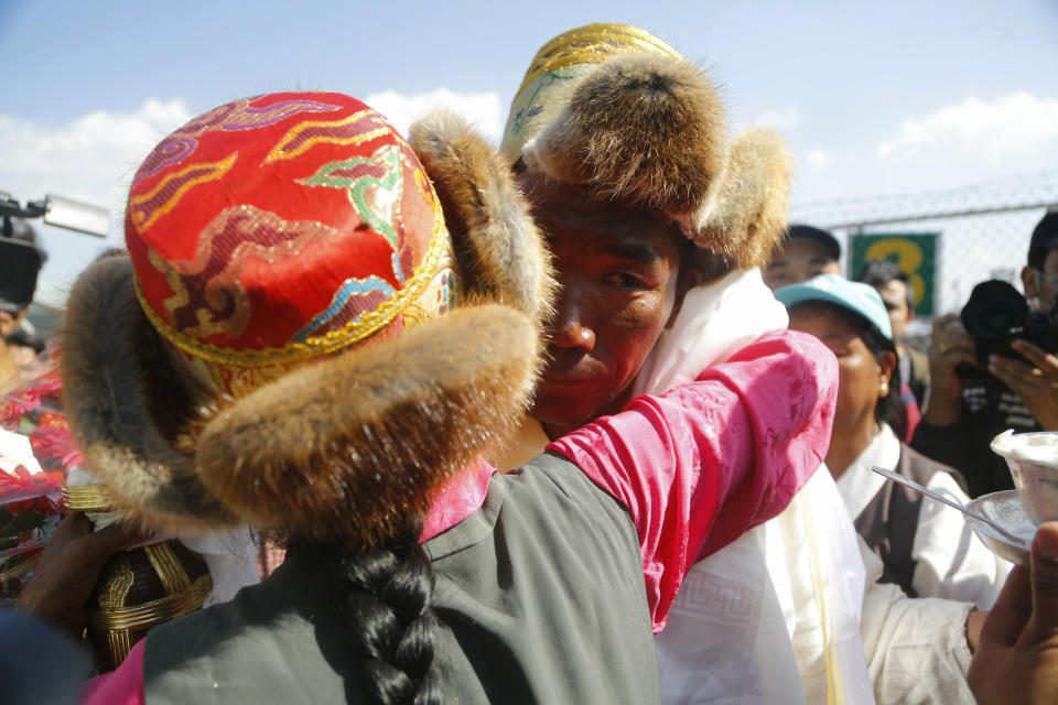 Nepalese veteran Sherpa guide Kami Rita, 49, is welcomed by his sister at the airport in Kathmandu, Nepal, Saturday, May 25, 2019. The Sherpa mountaineer extended his record for successful climbs of Mount Everest with his 24th ascent of the world's highest peak on Tuesday. (AP Photo/Niranjan Shrestha)