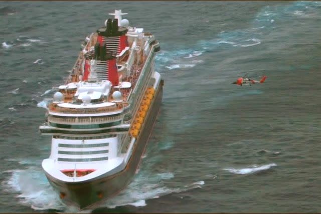 <p>United States Coast Guard</p> The helicopter hovers over the Disney Fantasy