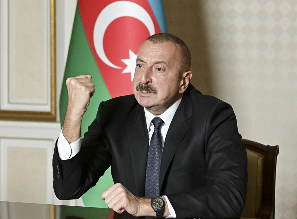 In this photo provided by the Azerbaijan's Presidential Press Office onTuesday, Oct. 20, 2020, Azerbaijani President Ilham Aliyev gestures as he addresses the nation in Baku, Azerbaijan. Armenia and Azerbaijan reported more fighting on Tuesday over the separatist territory of Nagorno-Karabakh, where clashes have continued for over three weeks despite two attempts at establishing a cease-fire. (Azerbaijani Presidential Press Office via AP)