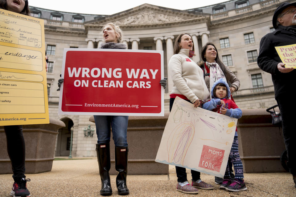 Protesters with Environment America stand outside the Environmental Protection Agency as Environmental Protection Agency Administrator Scott Pruitt holds a news conference on his decision to scrap Obama administration fuel standards, in Washington, Tuesday, April 3, 2018. (AP Photo/Andrew Harnik)