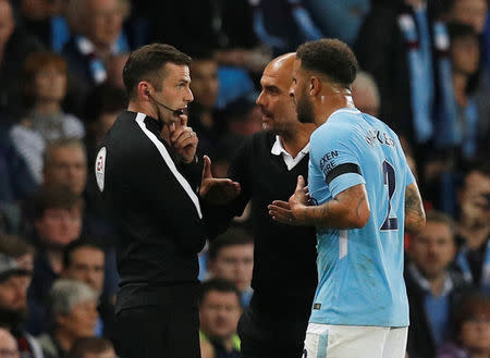 Soccer Football - Premier League - Manchester City vs Everton - Manchester, Britain - August 21, 2017 Manchester City manager Pep Guardiola and Kyle Walker speak with fourth official Michael Oliver as Walker walks off after being sent off REUTERS/Phil Noble