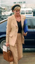 <p>This is by far one of our favourite looks. Here, Princess Diana is photographed at Heathrow Airport, as she prepares to board a flight to New York for a private preview of her dresses before they go to auction at Christie’s. Diana opted for a camel two-piece suit finished with a sleek headband for the momentous occasion. (PA)</p> 