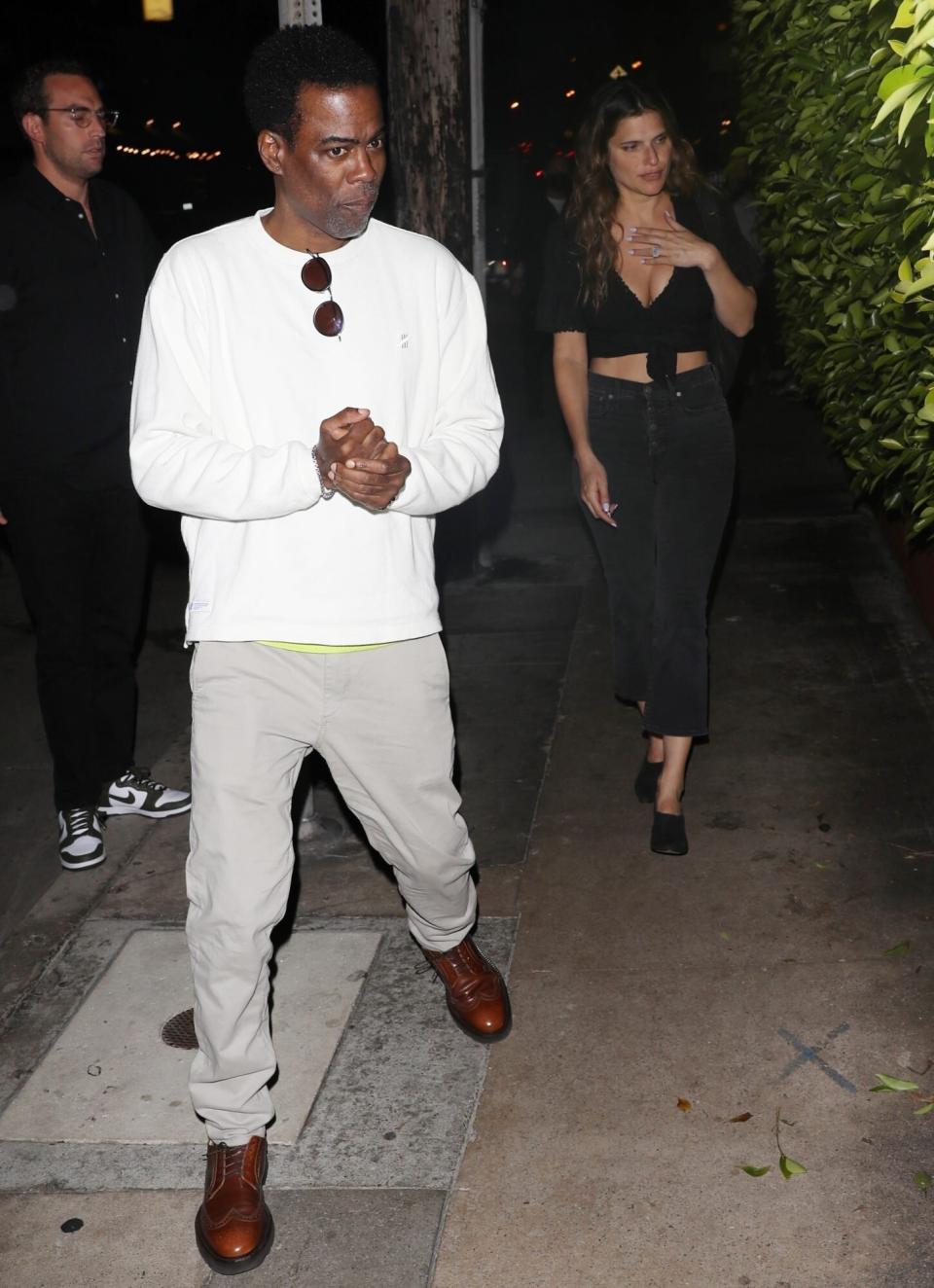 *PREMIUM-EXCLUSIVE* Santa Monica, CA - Comedian Chris Rock and actress Lake Bell are seen having a romantic dinner date at Italian restaurant Giorgio Baldi on the 4th of July weekend in Santa Monica. The duo arrived at 8:45 PM and left the establishment at 10:30 PM. The 57-year-old comedian kept it casual in a white long sleeve shirt, grey pants, and brown dress shoes while actress Lake Bell wore black jeans, black dress shoes, and a black top showing off a little bit of her cleavage. At one point, the couple was holding hands as they arrived at the restaurant but immediately let go of each other as soon as they saw the photographers. It’s been a little over 3 months since Chris Rock was slapped by actor Will Smith on stage in front of an audience and on live television at the 2022 Oscars. Chris and Lake were recently spotted together last month at Busch Stadium in St. Louis, watching a Cardinals game. Pictured: Chris Rock, Lake Bell BACKGRID USA 4 JULY 2022 BYLINE MUST READ: TPG / BACKGRID USA: +1 310 798 9111 / usasales@backgrid.com UK: +44 208 344 2007 / uksales@backgrid.com *UK Clients - Pictures Containing Children Please Pixelate Face Prior To Publication*