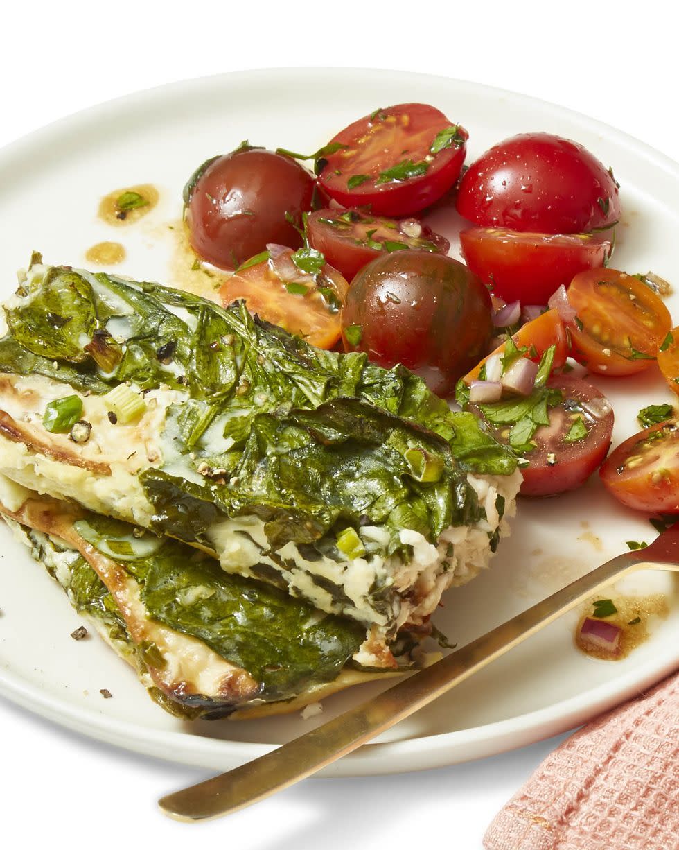 cheesy baked spinach and feta casserole on a white plate