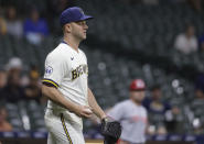 Milwaukee Brewers relief pitcher Brad Boxberger reacts after giving up a run to the Cincinnati Reds during the 10th inning of a baseball game Tuesday, June 15, 2021, in Milwaukee. (AP Photo/Jeffrey Phelps)