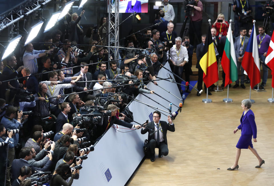 British Prime Minister Theresa May, right, arrives for an EU summit at the Europa building in Brussels, Thursday, Oct. 18, 2018. EU leaders meet for a second day on Thursday to discuss migration, cybersecurity and to try and move ahead on stalled Brexit talks. (AP Photo/Alastair Grant)