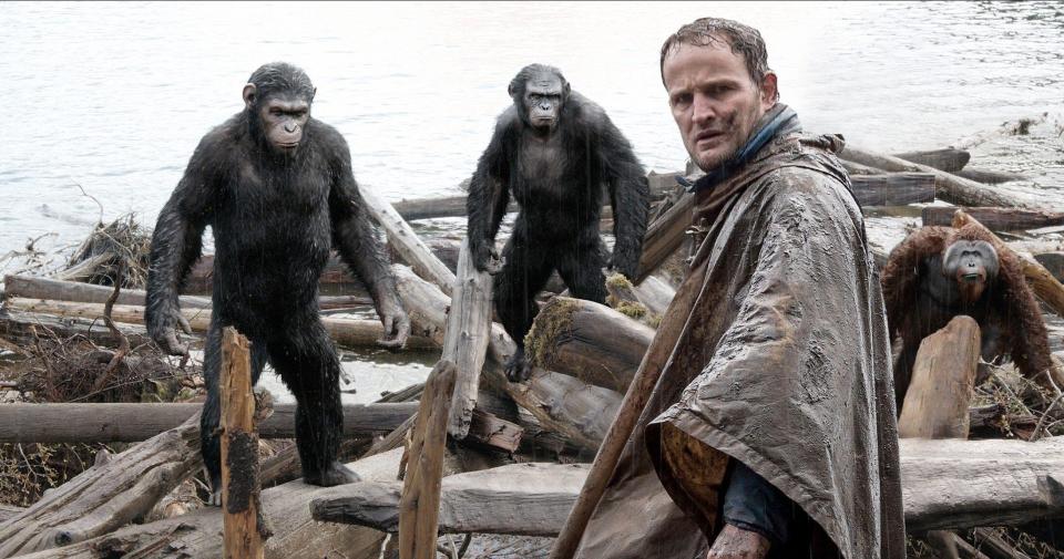 Jason Clarke standing with apes in a scene from Dawn of the Planet of the Apes