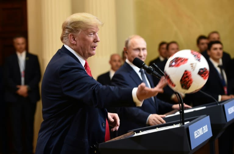 US President Donald Trump threw the soccer ball he received from Russia's President Vladimir Putin to aides, saying he would keep it for his 12-year-old son